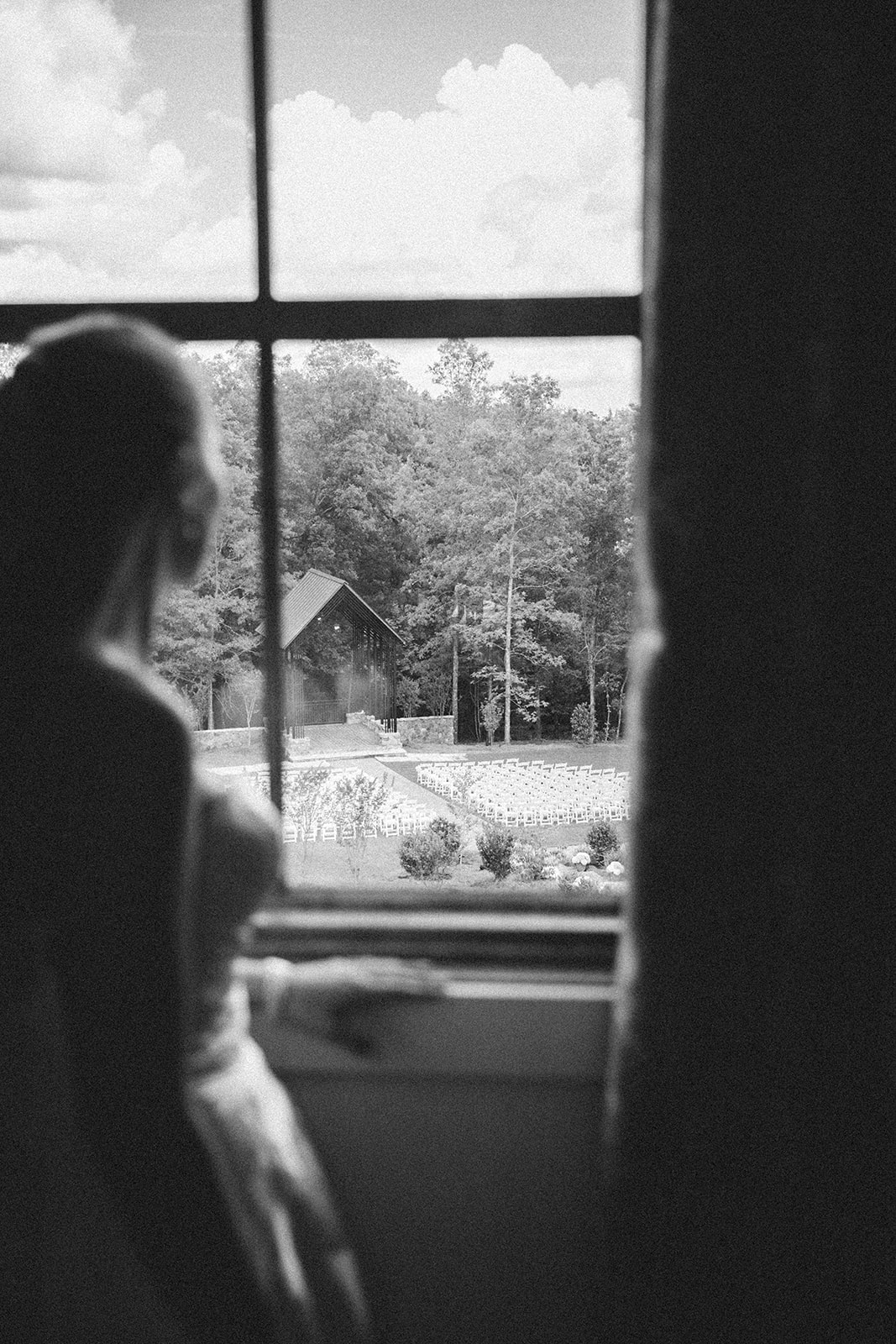 Bride looking out window at the chapel