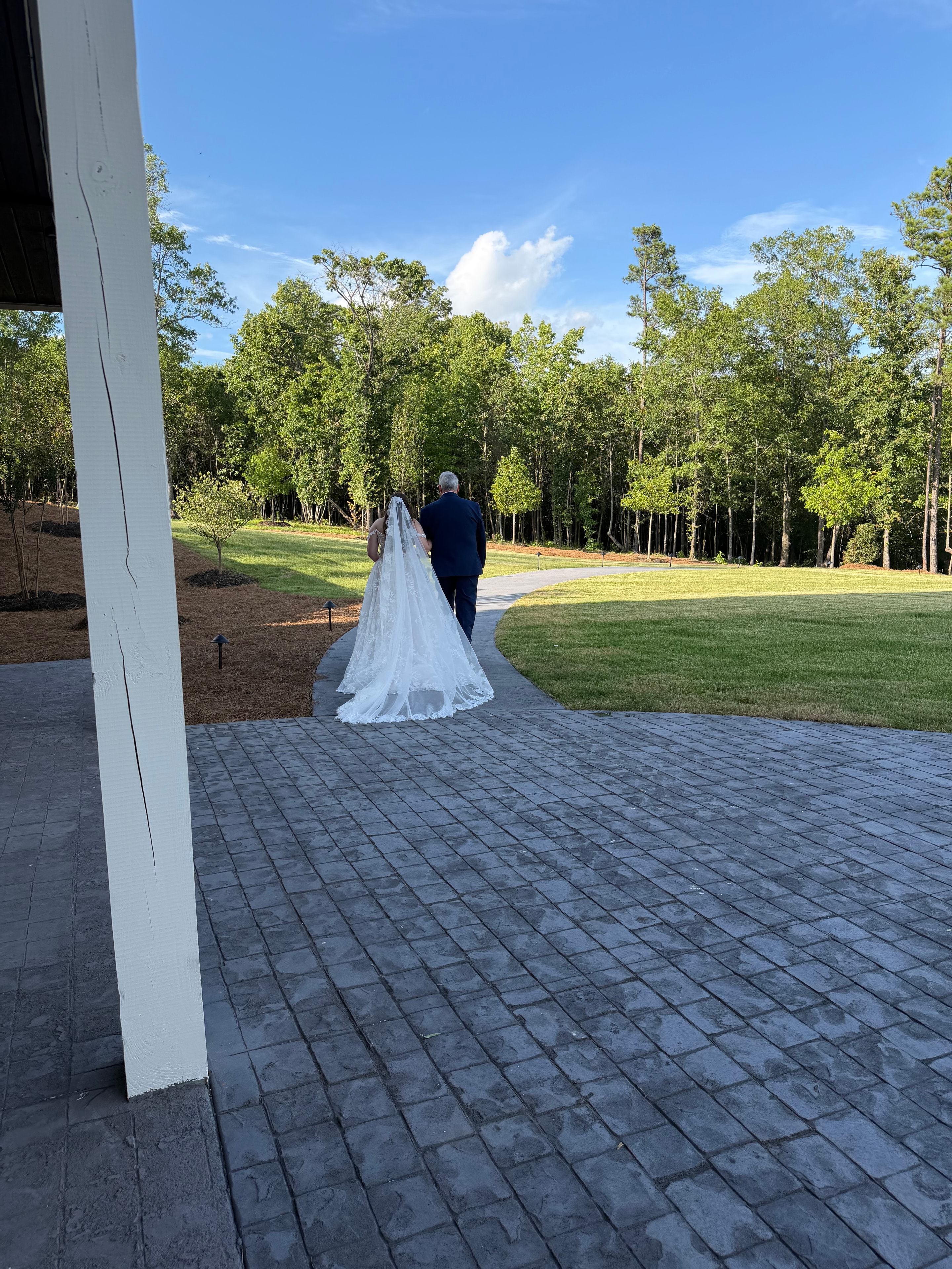 Bride on the stone walkway with open fields in the background