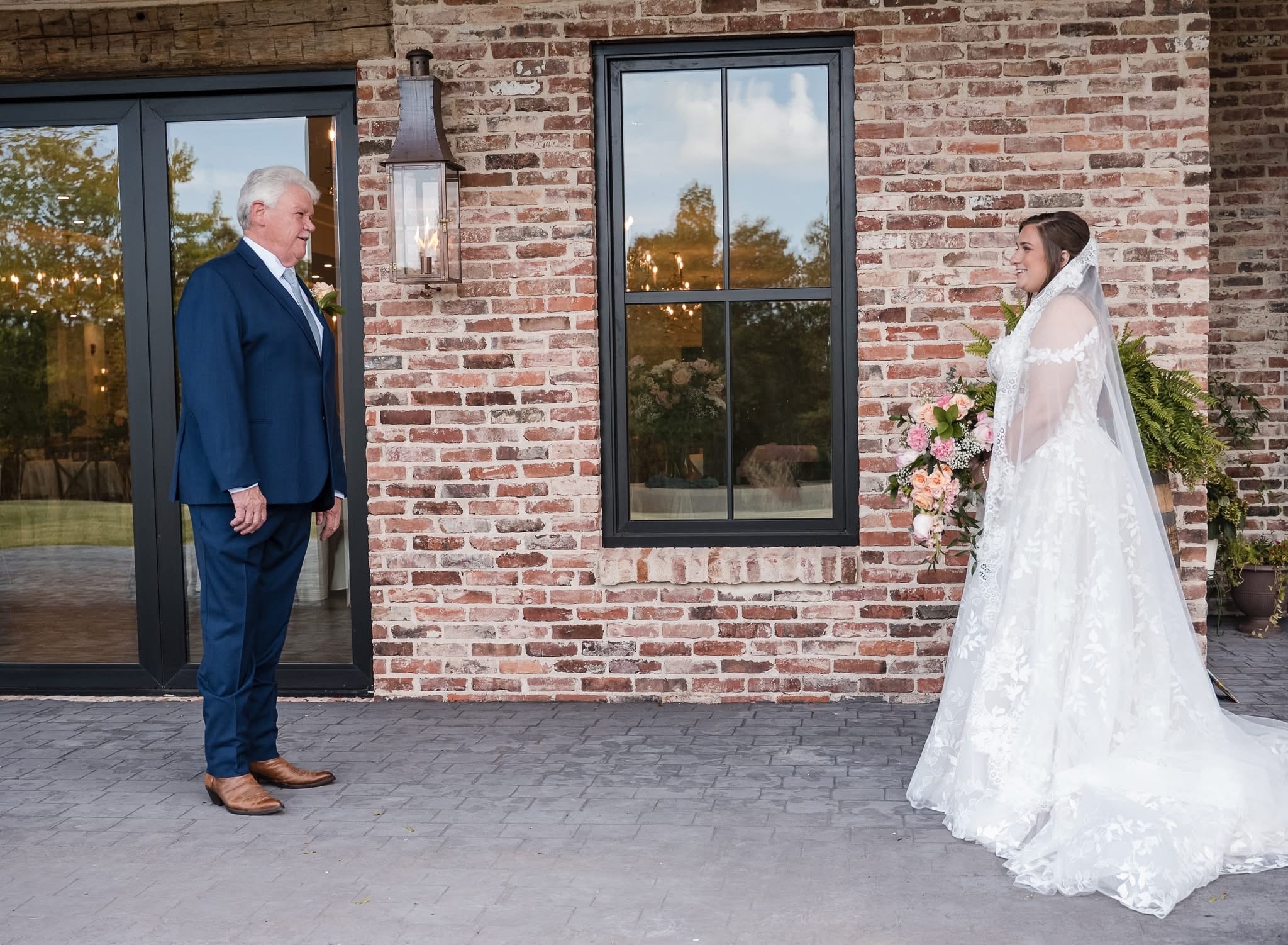 Father seeing his daughter in her wedding gown for the first time on the courtyard