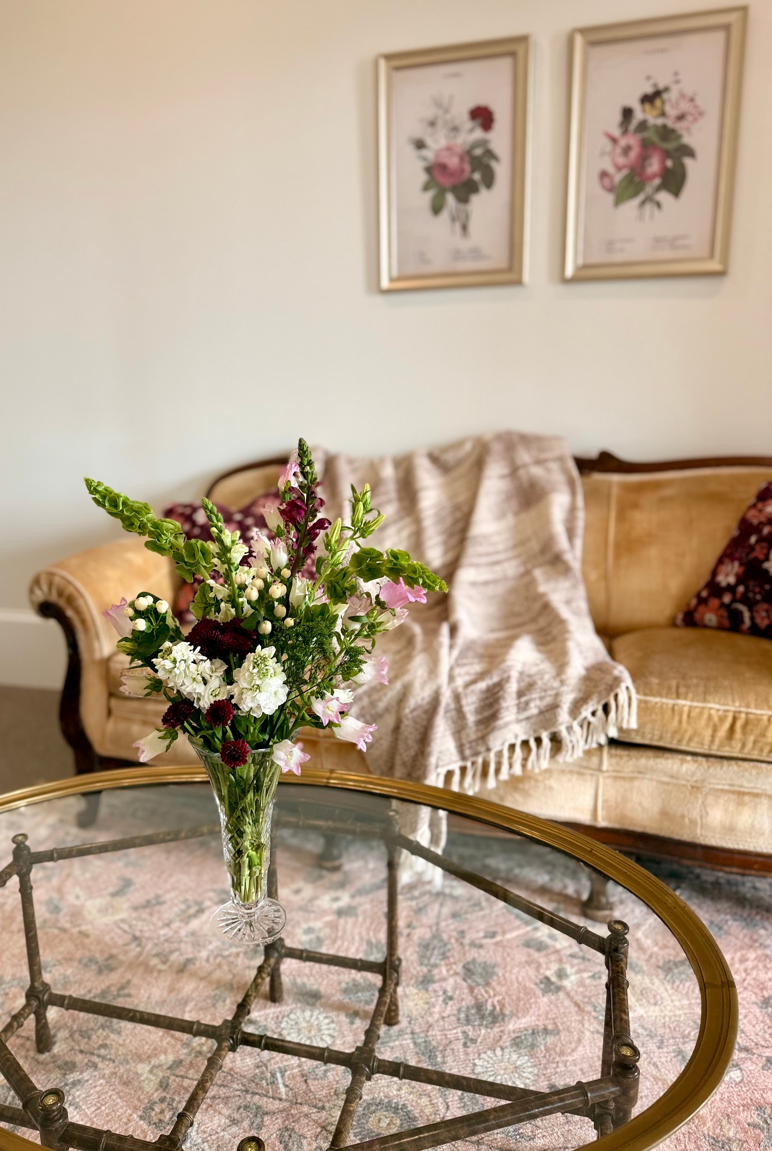 Fresh floral arrangement on glass coffee table in the bridal suite