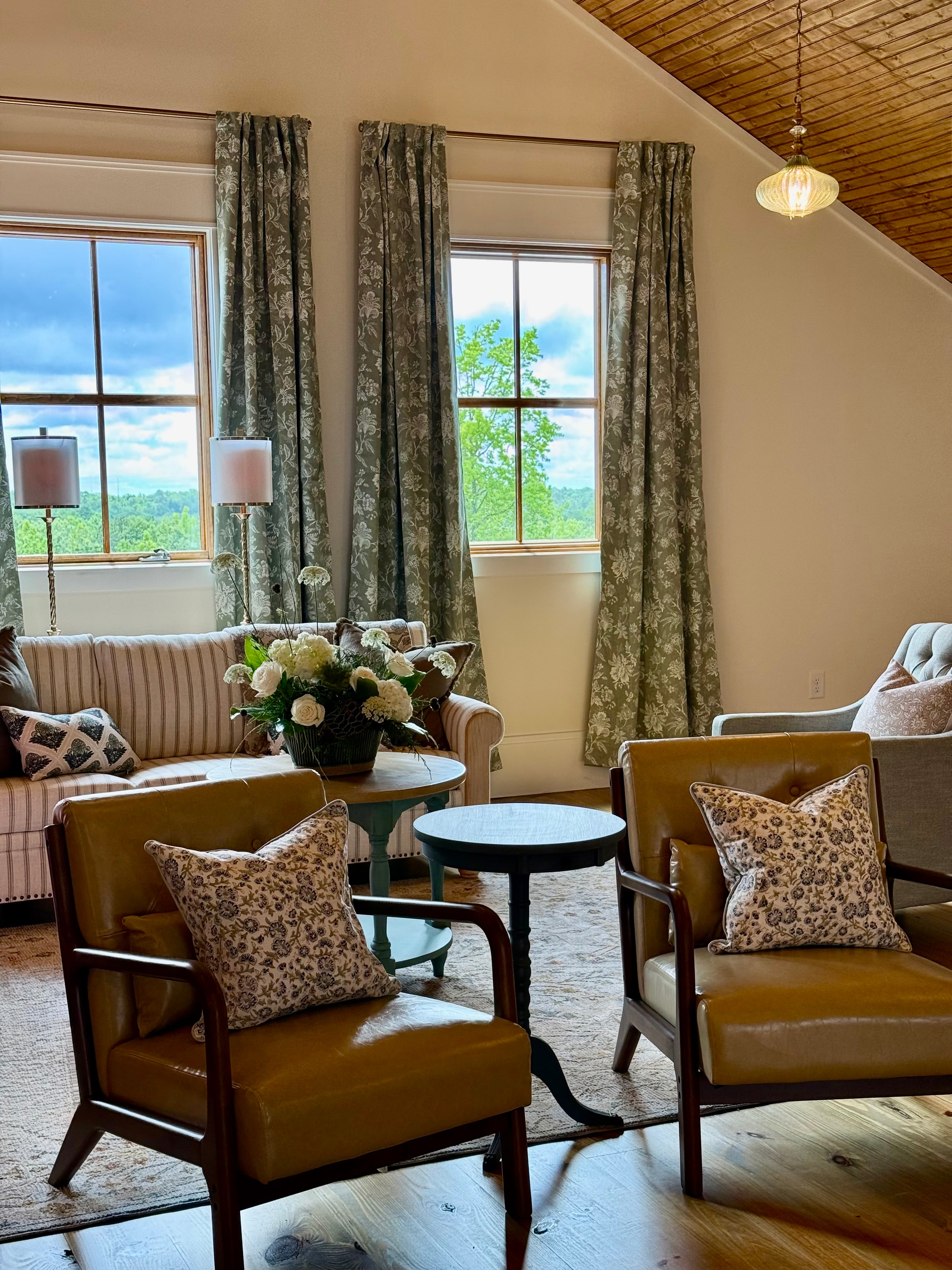 Bridal suite with leather chairs, floral curtains, and mountain views