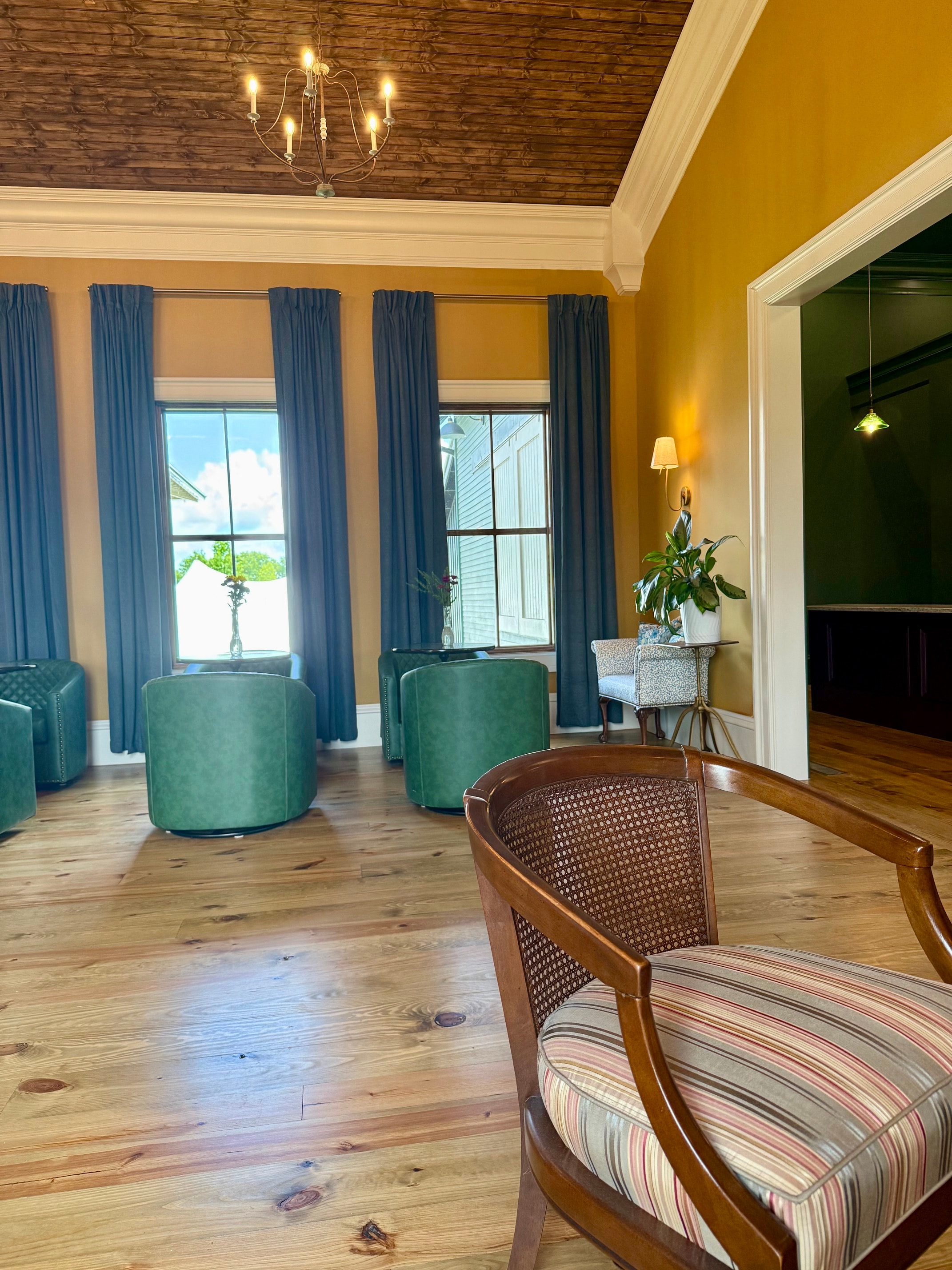 Bridal suite with vaulted wood ceiling, striped sofa, and floral centerpiece