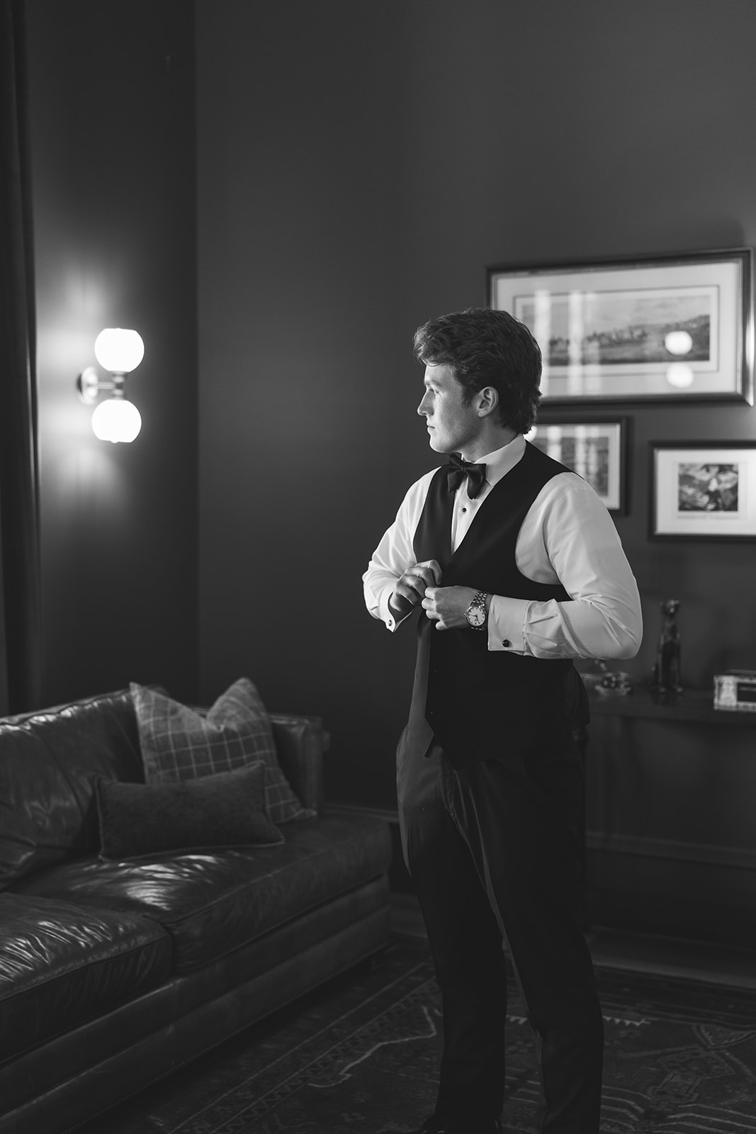 Black and white portrait of groom getting ready in the tasting room