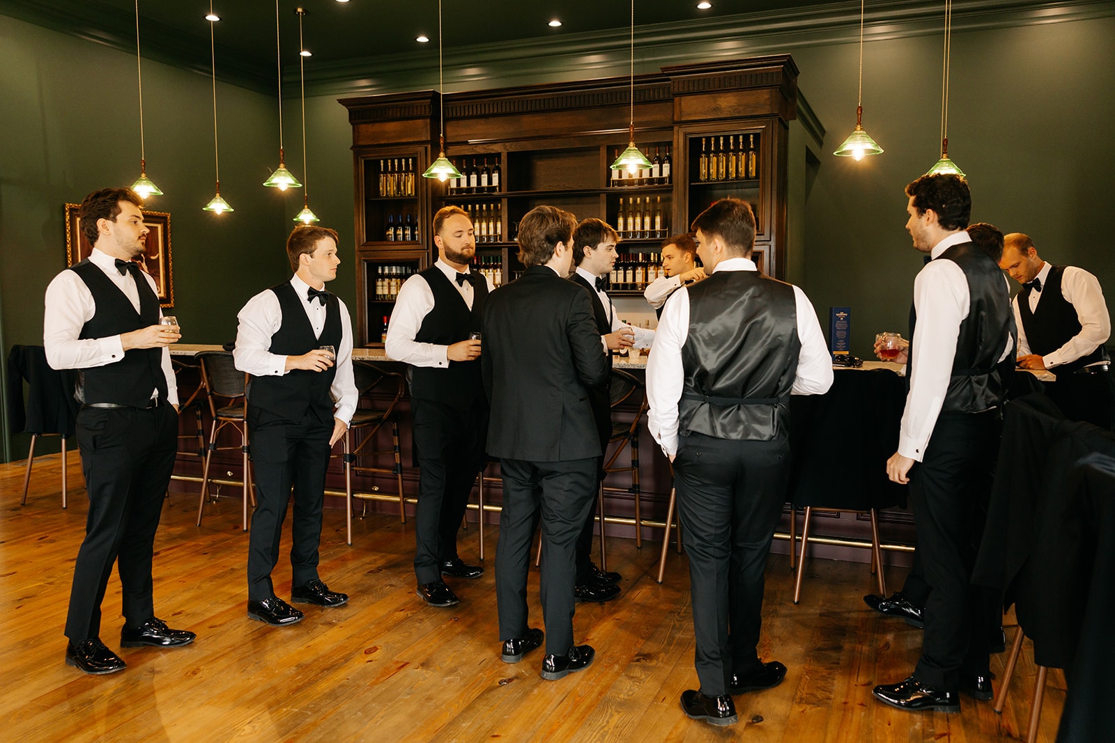 Groomsmen gathered around the bar in the tasting room