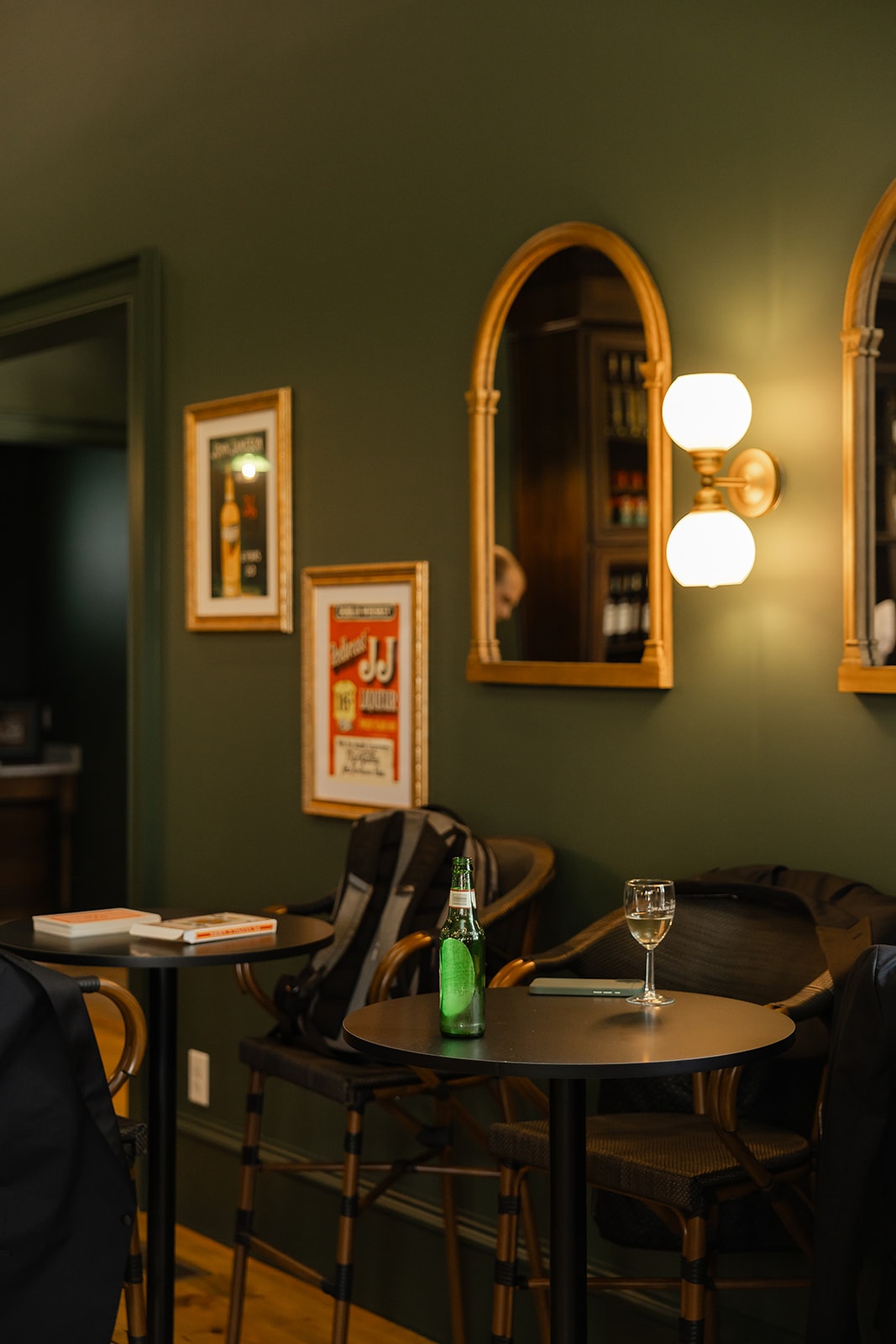 Intimate lounge tables with gold mirrors and warm sconce lighting
